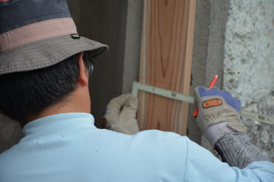 Mold testing technician inspecting wall cavity in Houston TX home